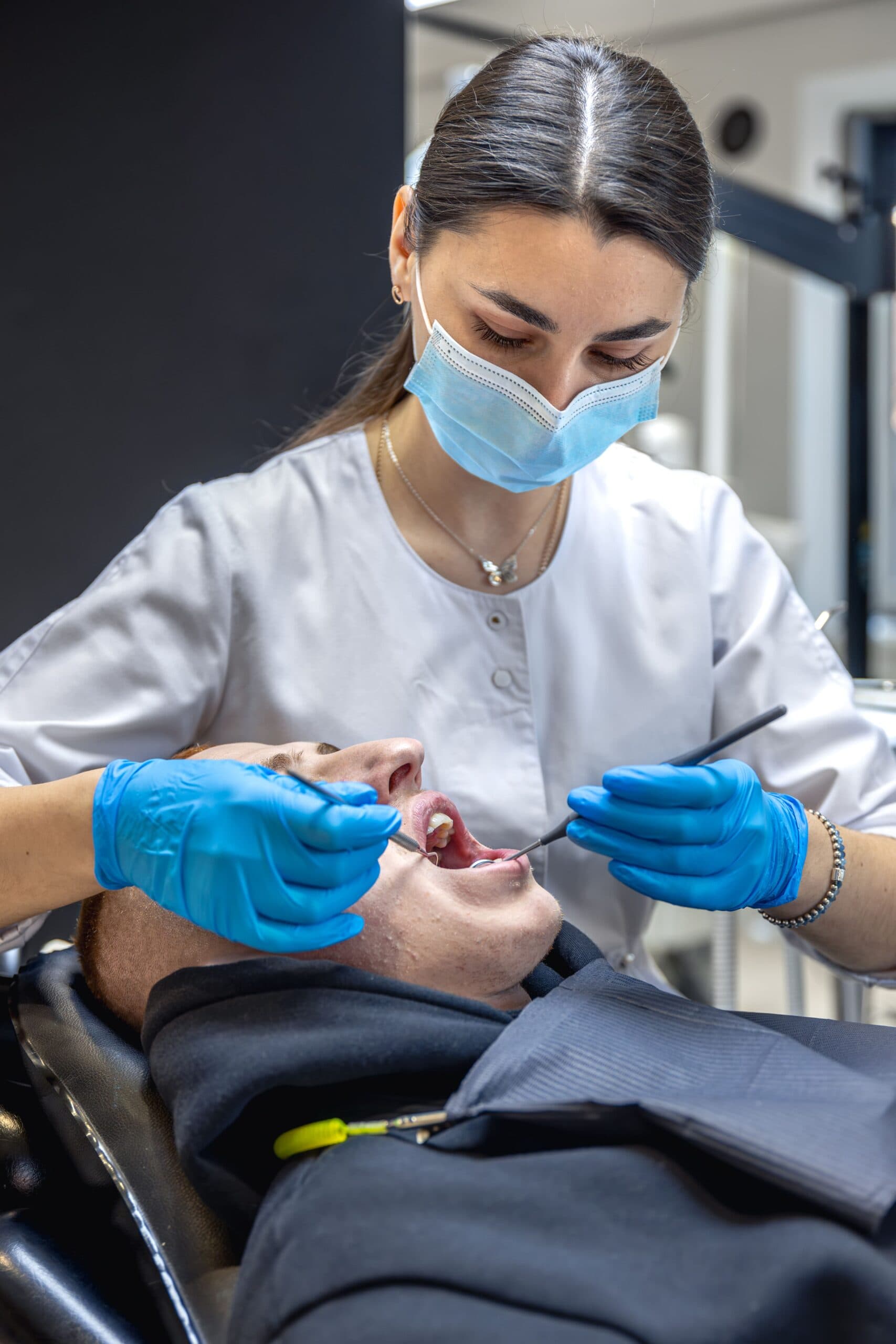 dentist-treats-patients-teeth-stomatologist-working-with-professional-equipment